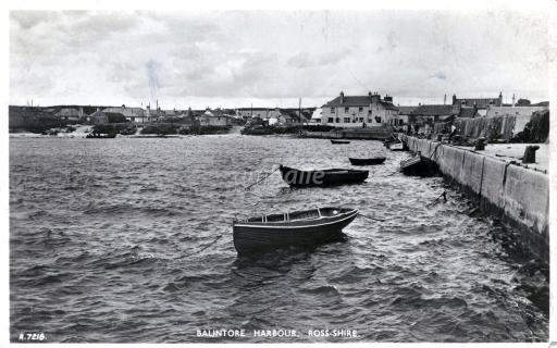 Postcard with a photograph of Balintore Harbour with small boats secured to posts, 1950s