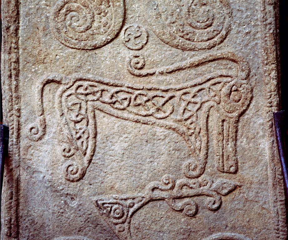 Pictish stones depicts beast with long snout, curled ears and hooked tail. Inscribed with knot designs.