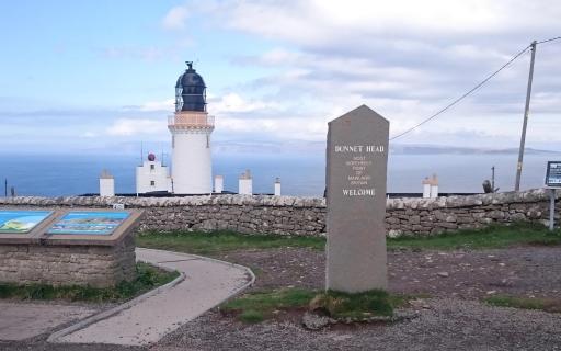 Overlooking Dunnet Head and Dunnet Head lighthouse. A large stone marker which reads "Dunnet Head Most Northerly Point of Mainland Britain. Welcome"