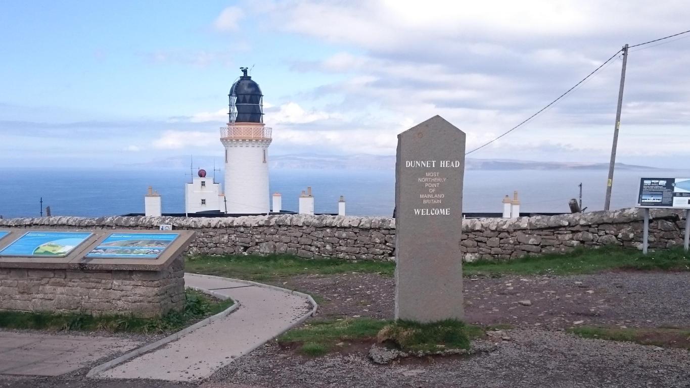 Overlooking Dunnet Head and Dunnet Head lighthouse. A large stone marker which reads "Dunnet Head Most Northerly Point of Mainland Britain. Welcome"