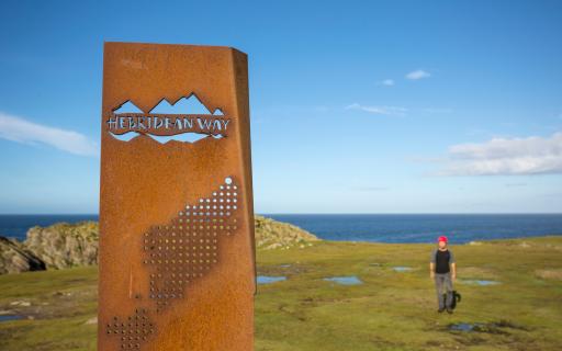 Iron sign for the Hebridean way with sea background