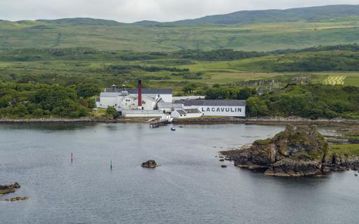 Lagavulin Distillery, white buildings with grey roofs, as seen as from the air