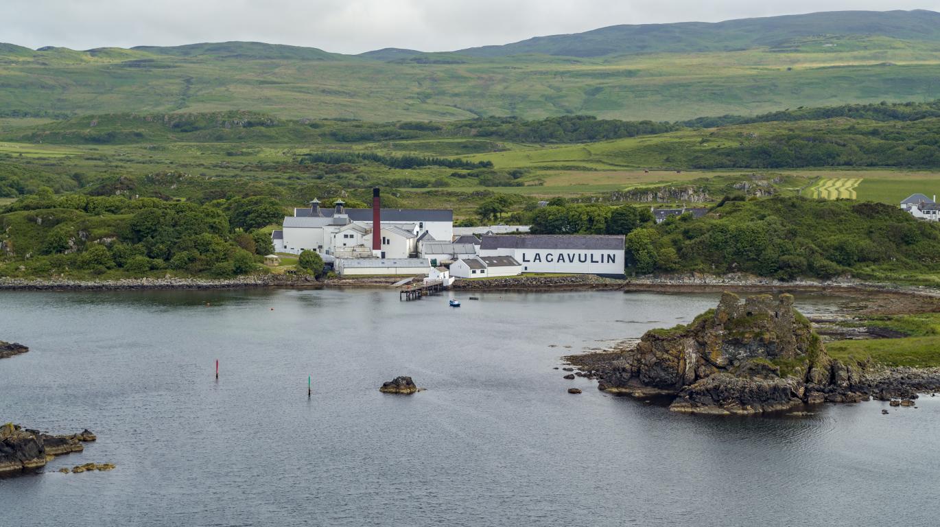 Lagavulin Distillery, white buildings with grey roofs, as seen as from the air