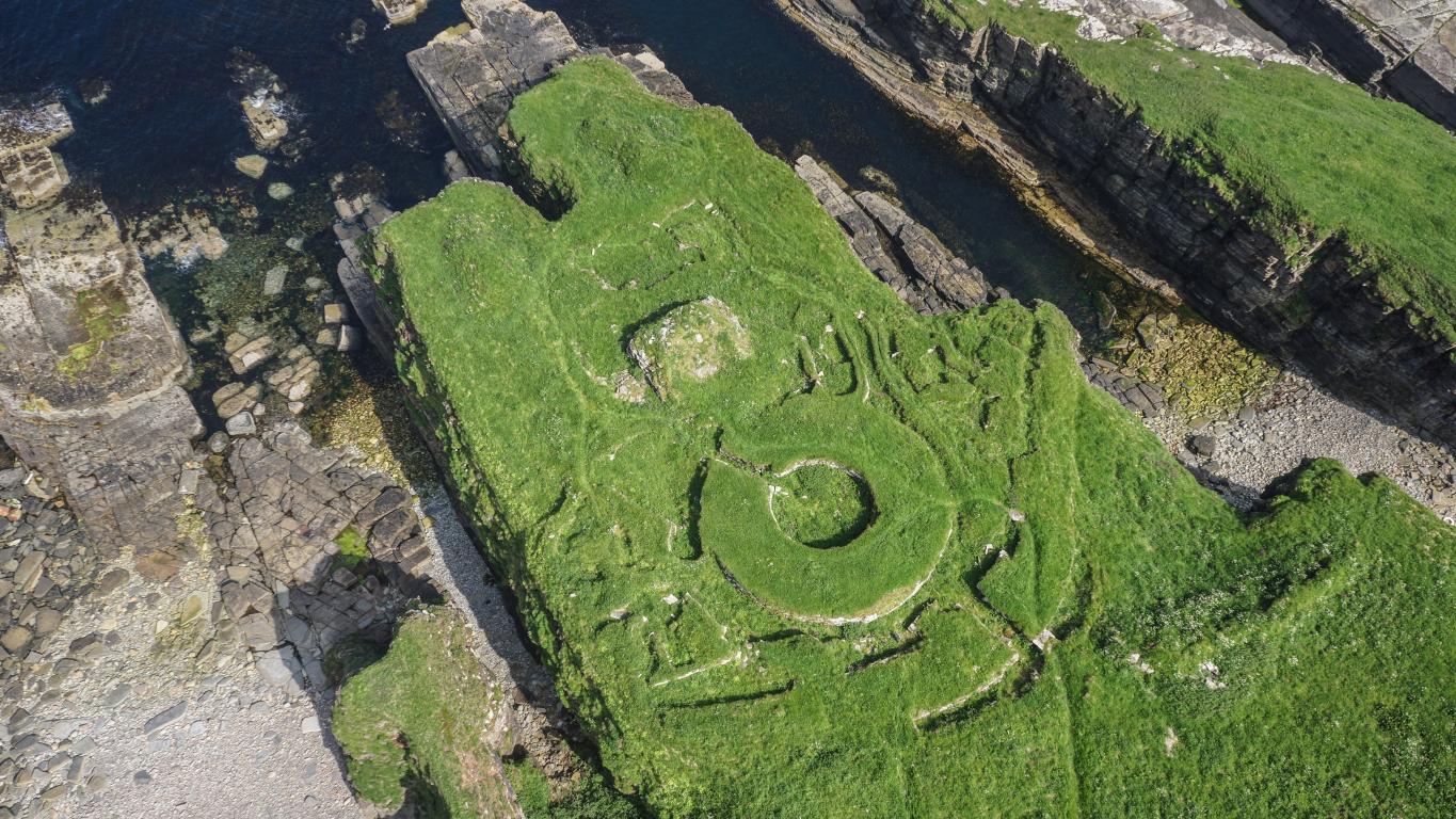 An overhead view of Nybster Broch, Caithness, situated next to a cliff edge