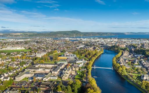 The city of Inverness in the summer sunlight. The River Ness winds through the city towards the Moray Firth towards the right hand side of the image.