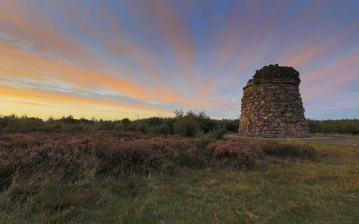 The Jacobite Cairn at Culloden Battlefield at sunset