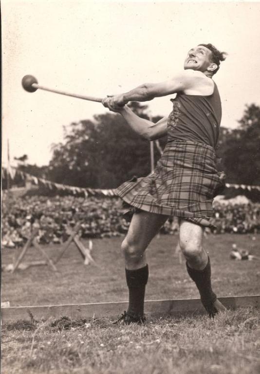 Black and white photograph of Big Jock preparing to swing a hammer.