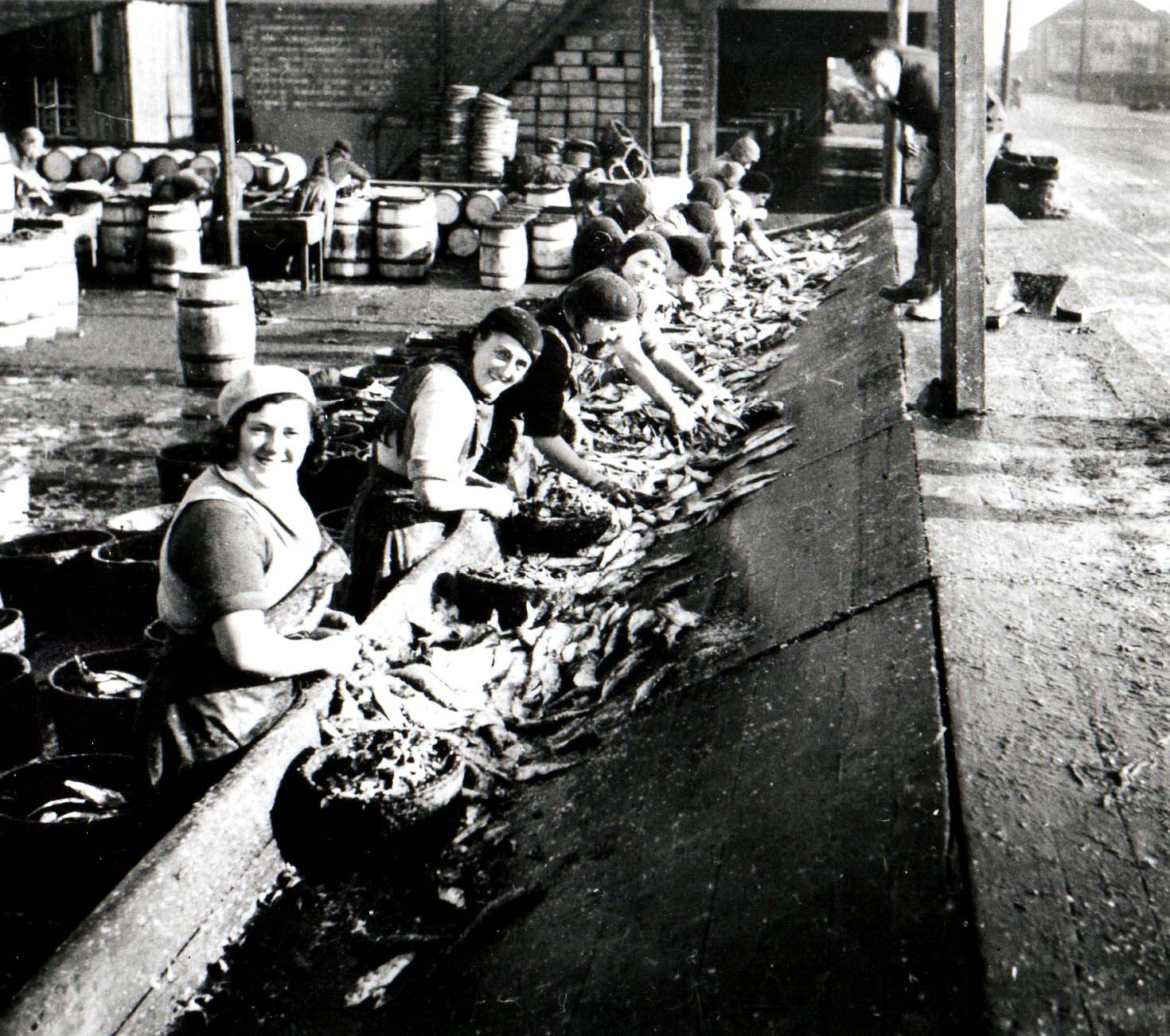 Black and white image of women preparing fish in Fishertown, Nairn
