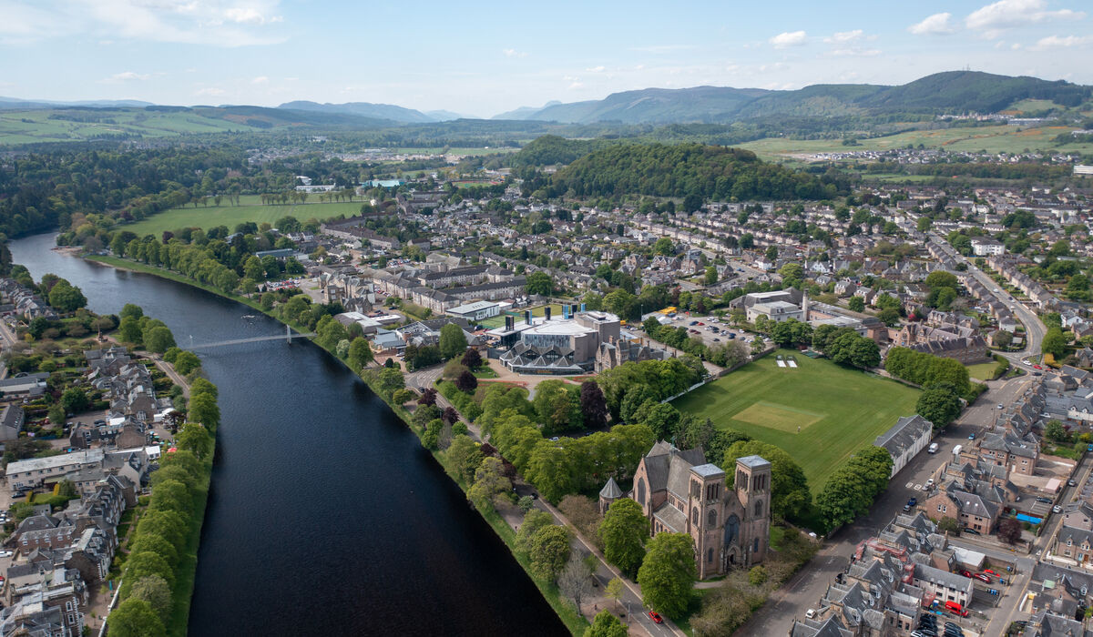 Image taken of the cityscape of Inverness from a drone. The River Ness runs through the city, seen on the left hand side of the image